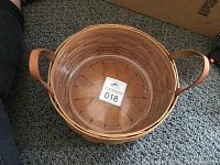 Top view showing basket interior, plastic liner, and leather handles.