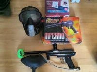 Paintball gun, paintball mask, and box with gun's original packaging.