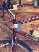 Red Raleigh M40 mountain/trail bike frame showing model markings and water bottle holder