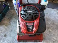 Top view of the red Craftsman engine with 190 CC displacement and 8.50 ft-lbs torque details, air intake vent, and black fuel tank.