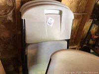 Stacked view of four Lifetime folding chairs showing the backrest with Lifetime branding and metal frame.