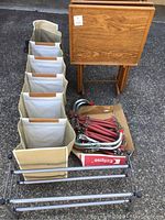 Fire escape ladder, TV trays, fabric hanging closet organizer, expandable shoe rack all visible together