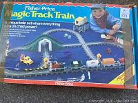 Box of Fisher Price Magic Track Train showing the train running on track and child playing with set.