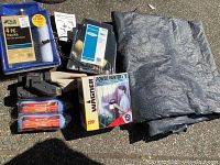 Full view showing Skil belt sander, Wagner Power Painter 220 kit in box, Wooster roller refills, Blue Hawk tray kit, roller covers, and tarp.