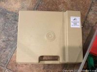 Beige hard plastic carrying case for Fisher Price record player, closed.