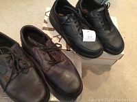 Two pairs of Rockport men's shoes, brown and black, seen from top and side angles to show condition and details.