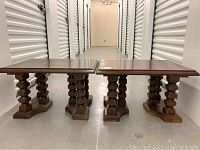 Front view of two wooden side tables showing rectangular tops and carved legs.