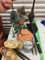 Overview of assorted garden items including wind chime, clay clock, solar fairy, garden tools and candles