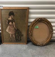 Full view of framed artwork of girl and dog alongside the ornate wooden oval frame showing size and condition.