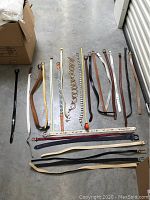 Photo showing all belts and metal chain accessories laid flat on floor for size and condition overview