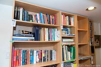 Wide view of large IKEA bookshelf filled with books, showing wood grain and size