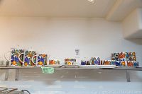 Wide shot of all Acapulco pattern dishes arranged on metal shelf