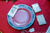 Overview of two card holders and glass plate on red background