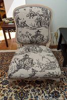 Front view of French-style accent chair with toile upholstery and wood frame