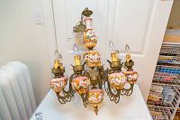 Full view of the Capodimonte ceramic and metal chandelier showing 8 arms with candle style bulbs and detailed ceramic hand painted sections.