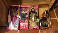 Four Barbie dolls in original and unopened boxes except Portuguese Barbie