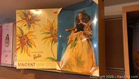 Front view of the boxed Sunflower Barbie inspired by Vincent Van Gogh with sunflower artwork visible on the box and doll dress.