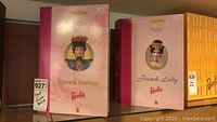 Photo of two Barbie collector doll boxes side by side, labeled Chinese Empress and French Lady.