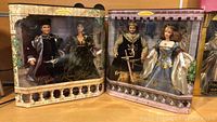 Both doll sets in sealed packaging side by side showing entire lot