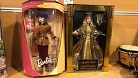 Two boxed collector dolls: Barbie Autumn in Paris and Elizabeth Taylor Cleopatra.