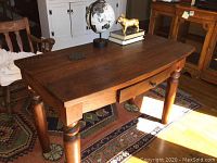 Full front-angle view of the entire wooden console table set on a patterned rug