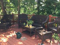 Full set on deck showing two chairs, loveseat, chaise lounge, table and stool