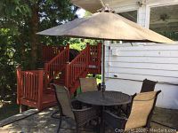 Overall view showing round table, four chairs, umbrella and base