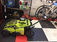 Side view of mower with battery in charger on deck