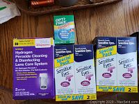 Photo showing Walgreens Hydrogen Peroxide Cleaning System twin pack, Opti-Free Replenish bottle, and Bausch and Lomb Sensitive Eyes Plus Saline Solution Special Pack (2 packs)