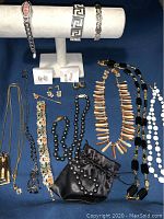 Full view of assorted ladies vintage jewelry including bracelets, necklaces, earrings and the Armitron wristwatch.