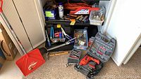 Lot of tools and accessories on floor and shelving including Durabuilt drill and various hand tools