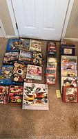 Overview of all 26 puzzles arranged on the floor, showing diverse box sizes and puzzle images.
