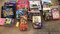 Overview image showing the grouped puzzles in their boxes arranged on the floor, showing a variety of sizes and images.