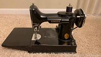 Side view of Singer Featherweight sewing machine with bed extension