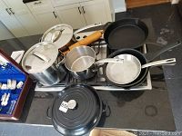 Overview of all pots and pans on stovetop, including Dutch oven, stockpot, saucepan, sauté pan, skillet, rolling pin