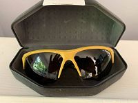 Front view showing Nike Skylon Ace sunglasses inside original contoured hard case with Nike logo inside lid.