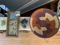 Overview of the lot items on a shelf: framed painting, wolf carving, basket, and jade tiger sculpture