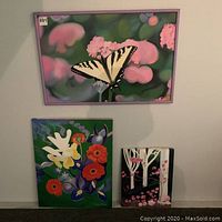 Three Caroline Millard original paintings, including a framed butterfly flower painting and two unframed floral artworks.