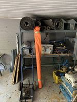 Full view showing aluminum vent caps, rolls of roofing paper, blue rip cart and boxes of piping joints