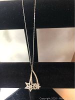 Front view of the silver-tone necklace with the dual star pendant featuring Swarovski crystals.