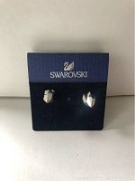 Front view of Swarovski silver crystal bolt style earrings on branded navy blue card.