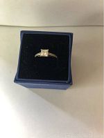 Top view of the Swarovski silver ring with square solitaire crystal in a blue box.