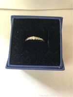 Silver-tone Swarovski crystal ring shown inside a blue jewelry box with black velvet lining.