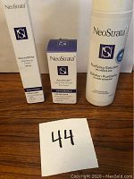 Three NeoStrata skincare products in original packaging on wooden surface, showing full view of boxes.