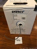 White box with Energy brand label indicating CAT5e wire, showing the cable spool and part of the gray cable extending from the box.