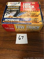 Box of the original Tow Truck In A Box Wide Track showing graphics and multilingual text indicating use for mud, sand, and snow traction for vehicles with large tires.