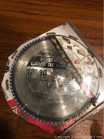 Photo of 12-inch Skil circular saw blade, showing blade teeth and printed label about size and teeth number.