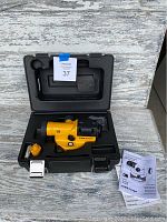 Complete set showing yellow automatic level inside black carrying case with manual and paperwork