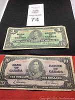 Stack of two vintage Bank of Canada bills showing $1 bill on top and $10 bill underneath.
