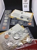 Photo showing three sets of Canadian coins sealed in plastic with accompanying information cards.